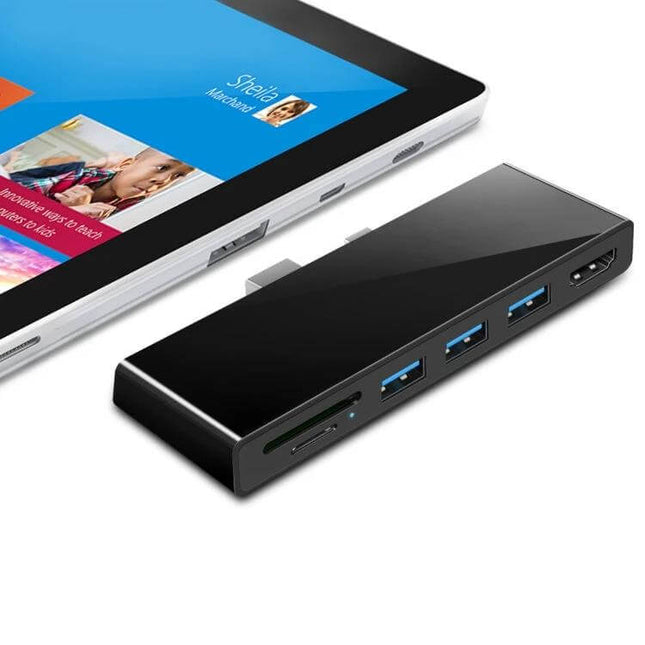 Rocketek Versatile USB Hub with HDMI and Card Reader shown connected to a tablet, featuring three USB 3.0 ports, HDMI and SD card slots