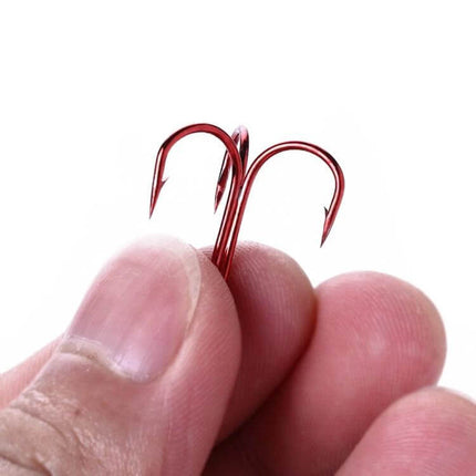 HENGJIA Classic Red Three Jaw Treble Hooks For Freshwater Fishing - close-up of red three-jaw treble hook held between fingers