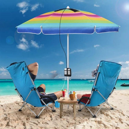 HAWEEL Foldable Solar Charger for Portable Device Powering charging phones beneath a beach umbrella between two lounge chairs