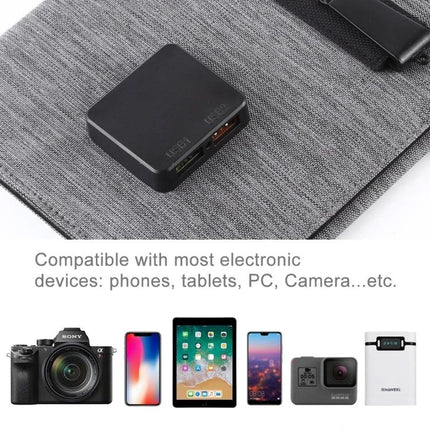 HAWEEL Foldable Ultrathin Solar Panel Charger for Portable Power powering phones, tablets and cameras on a gray fabric surface