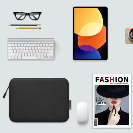 HAWEEL Protective Sleeve Case for 9.7 to 11 Inch Tablets flatlay showing black protective sleeve with tablet, keyboard, mouse, glasses and magazine