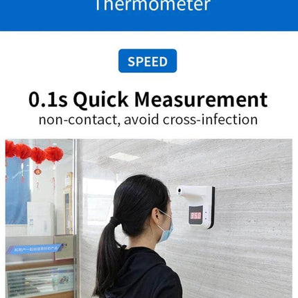 Handsfree Non-Contact Forehead Infrared Thermometer For Home Use wall-mounted unit measuring masked woman's forehead at entryway, 0.1s quick, handsfree screening