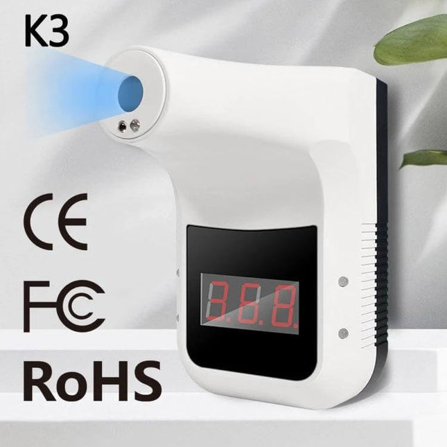 Handsfree Non-Contact Forehead Infrared Thermometer For Home Use wall-mounted white unit with red digital display and handsfree sensor