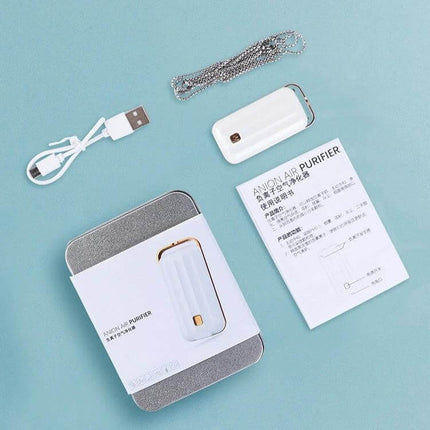 Hanging Neck Negative Ion Air Purifier Portable For Daily Use - white portable unit with lanyard, USB cable, and manual laid out