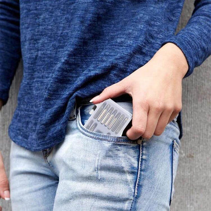 Hoshe 16 in 1 Mini Screwdriver Set for Watch and Eyeglasses Repairs - compact kit being placed into jeans pocket, showing interchangeable bits and ergonomic case