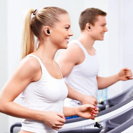 Wireless Noise Cancelling Earbuds With Charging Case worn by runners on treadmills for workouts and clear calls, compact charging case