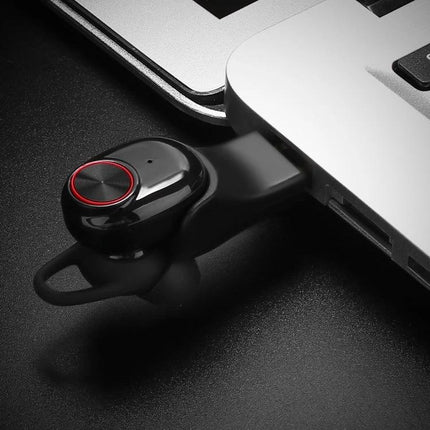 Wireless Noise Cancelling Earbuds With Charging Case showing compact black earbud in charging cradle near laptop USB port, sport-ready