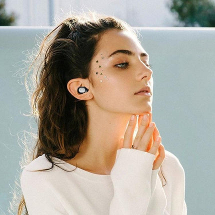 True Wireless Earbuds For Everyday Listening With Charging Case shown in-ear on woman commuting with charging case features and Bluetooth 5.0