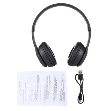 Foldable Wireless Bluetooth Headphones With 3.5mm Jack shown folded with USB charging cable and instruction manual, commuter-ready