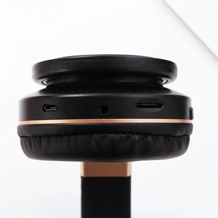 Candy Color Bluetooth Headphones With On Ear Controls For Daily Use black earcup close-up showing ports and on-ear controls for commuting