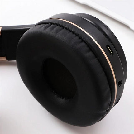 Candy Color Bluetooth Headphones With On Ear Controls For Daily Use black earcup closeup showing on-ear controls and charging port