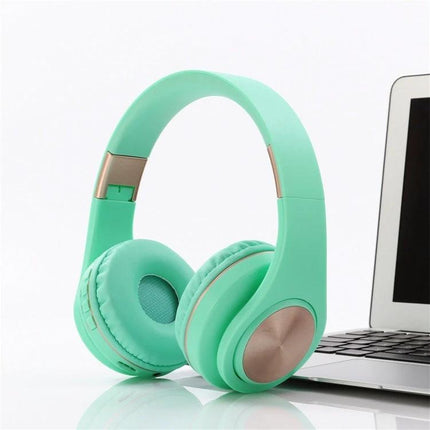 Candy Color Bluetooth Headphones With On Ear Controls For Daily Use in mint green beside a laptop, Bluetooth 4.2, on-ear controls