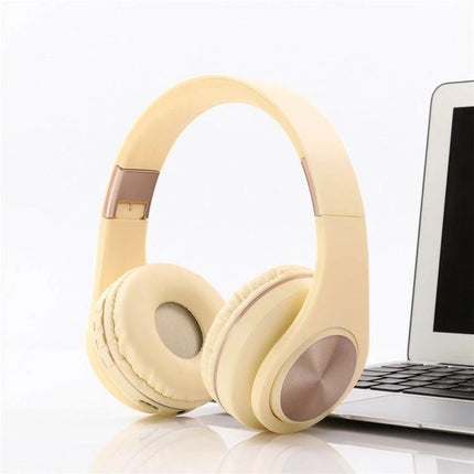 Candy Color Bluetooth Headphones With On Ear Controls For Daily Use in pastel yellow beside a laptop, Bluetooth 4.2, on-ear controls