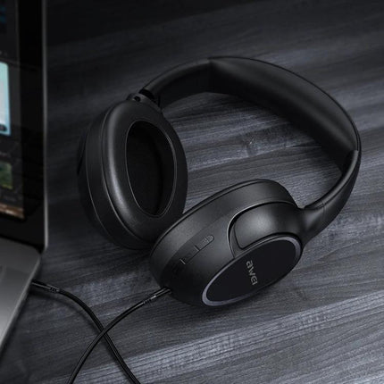 Awei Wireless Folding Headset For Calls And Commuting Use shown in black Bluetooth over-ear foldable headphones on desk