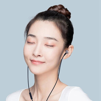Xiaomi Wired 3.5mm Earphones With Inline Remote Aluminum shown worn by woman enjoying music with inline remote control