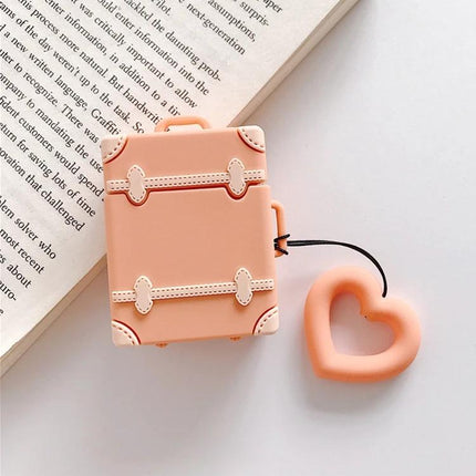 Protective Silicone Case for Daily AirPods Carry in Bright Colors shown as a peach travel suitcase style AirPods cover with heart charm