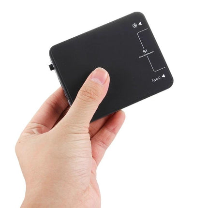 Multi-Port USB Charger for Everyday Home Device Use - compact black 6-port charger held in hand to power phones and tablets