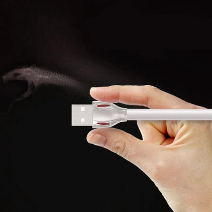 REMAX Cable for Travel and Daily Device Charging Needs - compact white USB cable held between fingers for travel and daily charging