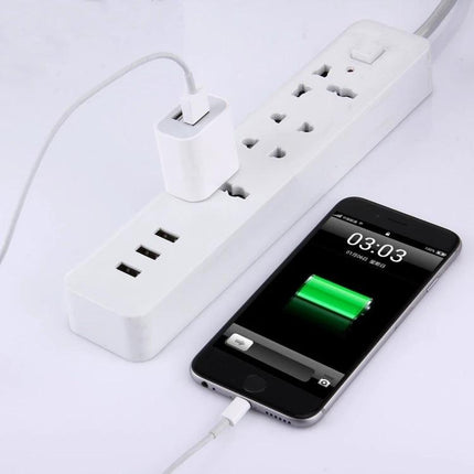 Compact Charger for Daily Device Powering at Home and Travel shown charging phone and tablet from compact dual-USB adapter on power strip