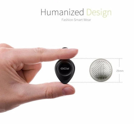 QCY Single Wire Bluetooth Earphone For Commuting And Calls compact black earbud held between fingers beside 25mm coin