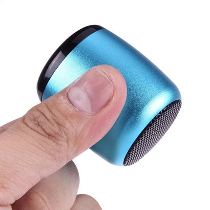 Compact Bluetooth Speaker For Music And Hands Free Calls shown held between thumb and finger in metallic blue pocket-sized design