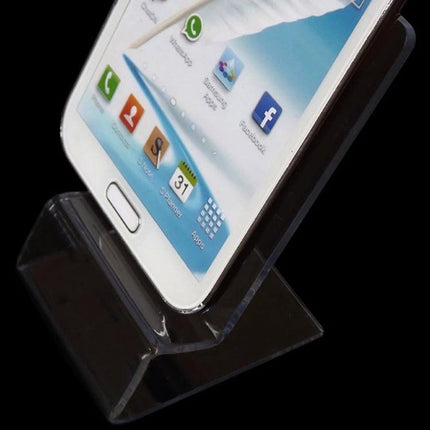 Transparent Acrylic Stand for Smartphones Up to 5.5 Inches holding a white smartphone for hands-free viewing on a desk