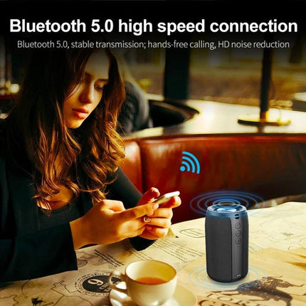 ZEALOT Portable Bluetooth Speaker For Home And Travel Background Music shown on cafe table with smartphone, coffee, woman using phone