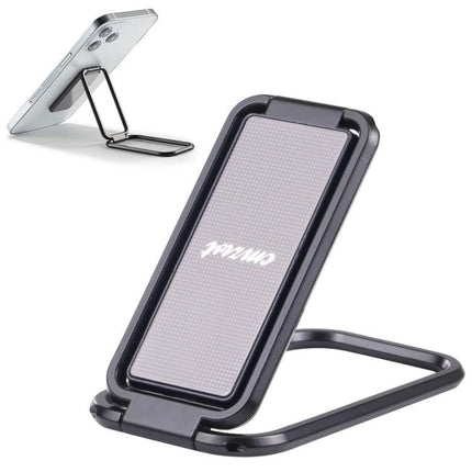 Cmzwt Adjustable Folding Magnetic Desk Phone Holder in black propped on desk holding smartphone, foldable compact stand for video calls and viewing