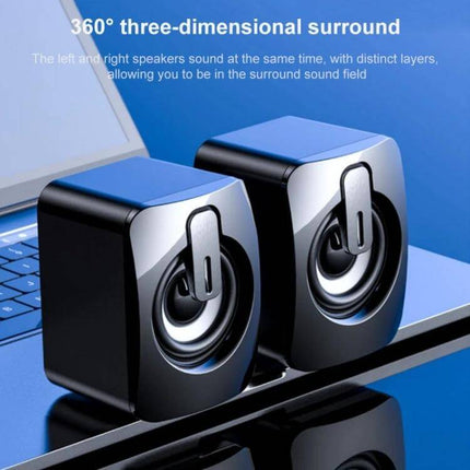 Compact Bluetooth USB Speaker For Desk Bedside Travel shown as compact twin desktop speakers beside a laptop