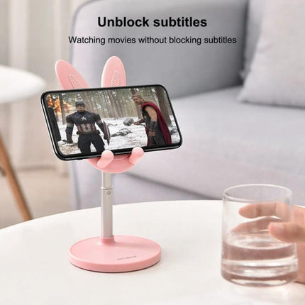 Foldable Adjustable Desktop Holder for Phones and Tablets holding a phone horizontally on a pink cute desktop stand for hands-free video and unobstructed subtitles