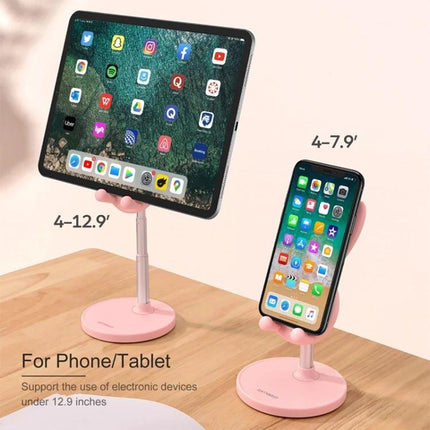 Foldable Adjustable Desktop Holder for Phones and Tablets on desktop in pink holding tablet and phone, adjustable height for 4–12.9" devices