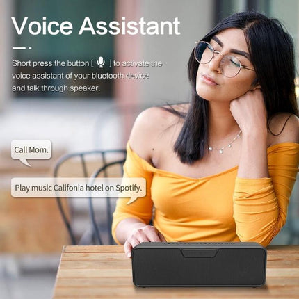 XDOBO Portable Bluetooth Speaker For Outdoor And Home Use showing woman using voice assistant with speaker on table