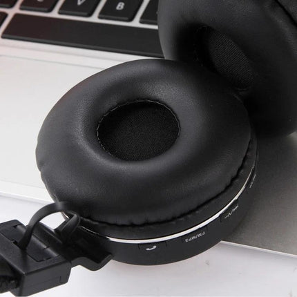 Jieli Wireless Bluetooth Headset For Commuting And Calls shown on laptop, black over-ear earcup highlighting controls and padding