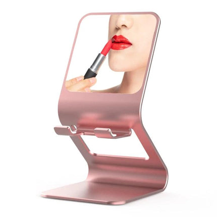 Metal Desktop Stand for Phones, Tablets and Makeup Mirror in rose gold holding a phone and built-in mirror for makeup application
