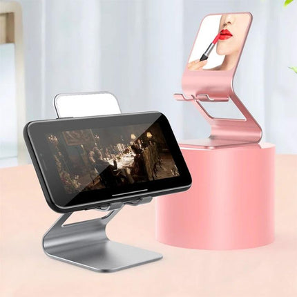 Metal Desktop Stand for Phones, Tablets and Makeup Mirror in silver and pink showing phone landscape video and mirror for makeup