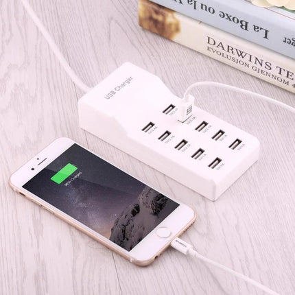 Versatile 10-Port USB Charger for Everyday Home Devices showing 10 USB ports charging a smartphone on a desk