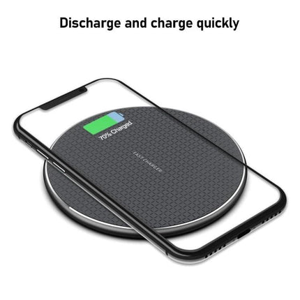 Essential K8 Wireless Charger for Daily Office Use - compact black wireless charging pad on office desk charging smartphone, no cords