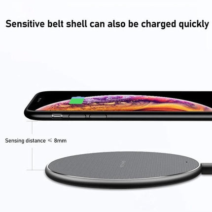Essential K8 Wireless Charger for Daily Office Use on a desk charging a phone through case, low-profile round pad with ≤8mm sensing distance