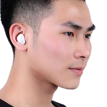 Wireless Earbuds With Secure Fit For Running And Commuting white compact earbuds worn by man for music and calls