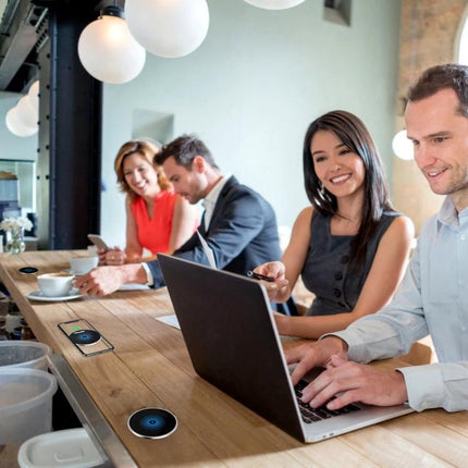 Embedded Wireless Charger for Desk Use in Daily Settings – discreet in-desk charger powering phones at cafe-style workspace