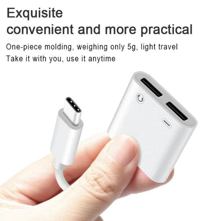Versatile USB-C Adapter for Audio and Charging in Daily Life - compact white dual-port adapter held between fingers for charging and audio