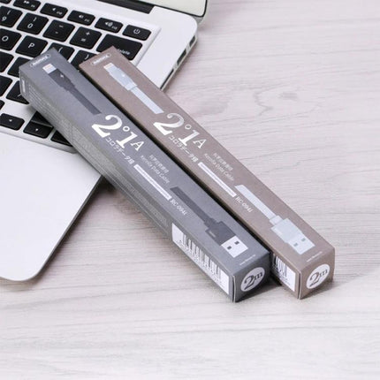 REMAX USB to Lightning Cable for Daily Device Charging - 2m charging cable boxed next to laptop for desk, car and travel use