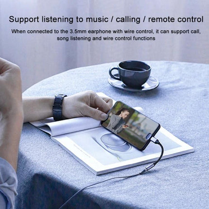 Adapter for Connecting USB-C Devices to 3.5mm Headphones Daily plugged into smartphone on table for music and calls