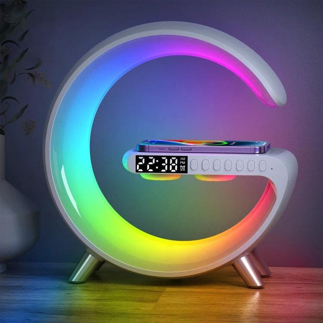 Compact Home Speaker With Wireless Charging And Ambient Light on nightstand with phone charging and rainbow sunrise glow