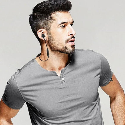 Lightweight Neckband Earbuds For Commuting And Hands Free Calls shown on a fit man wearing magnetic earbuds and flexible neckband