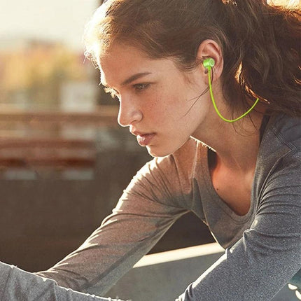 Neckband Earphones With Magnetic Buds For Commuting And Jogging showing a woman jogging with green magnetic earbuds and flexible neckband