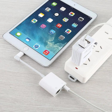 Essential Adapter for Daily Device Connectivity and Charging connecting iPad via Ethernet RJ45 while charging from power strip for stable hotel or travel internet