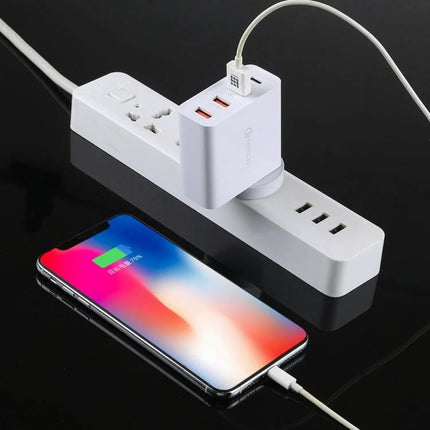 Compact Wall Charger for Everyday Device Charging at Home showing multi-port USB charging phone and earbuds on a power strip