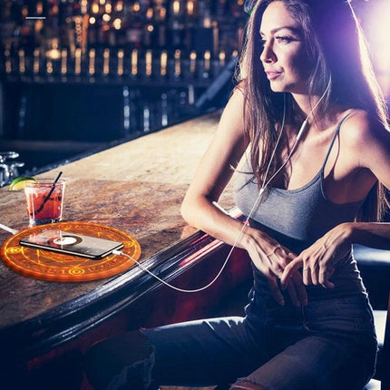 Wireless Charger for Daily Home and Travel Essentials on bar counter beside a woman listening to music, portable cord-free charging