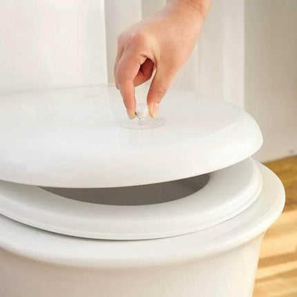 Invisible Cabinet Drawer Handle 2 Pack With Self Adhesive Suction Cups - clear acrylic suction cup handle on toilet lid showing easy no-drill installation